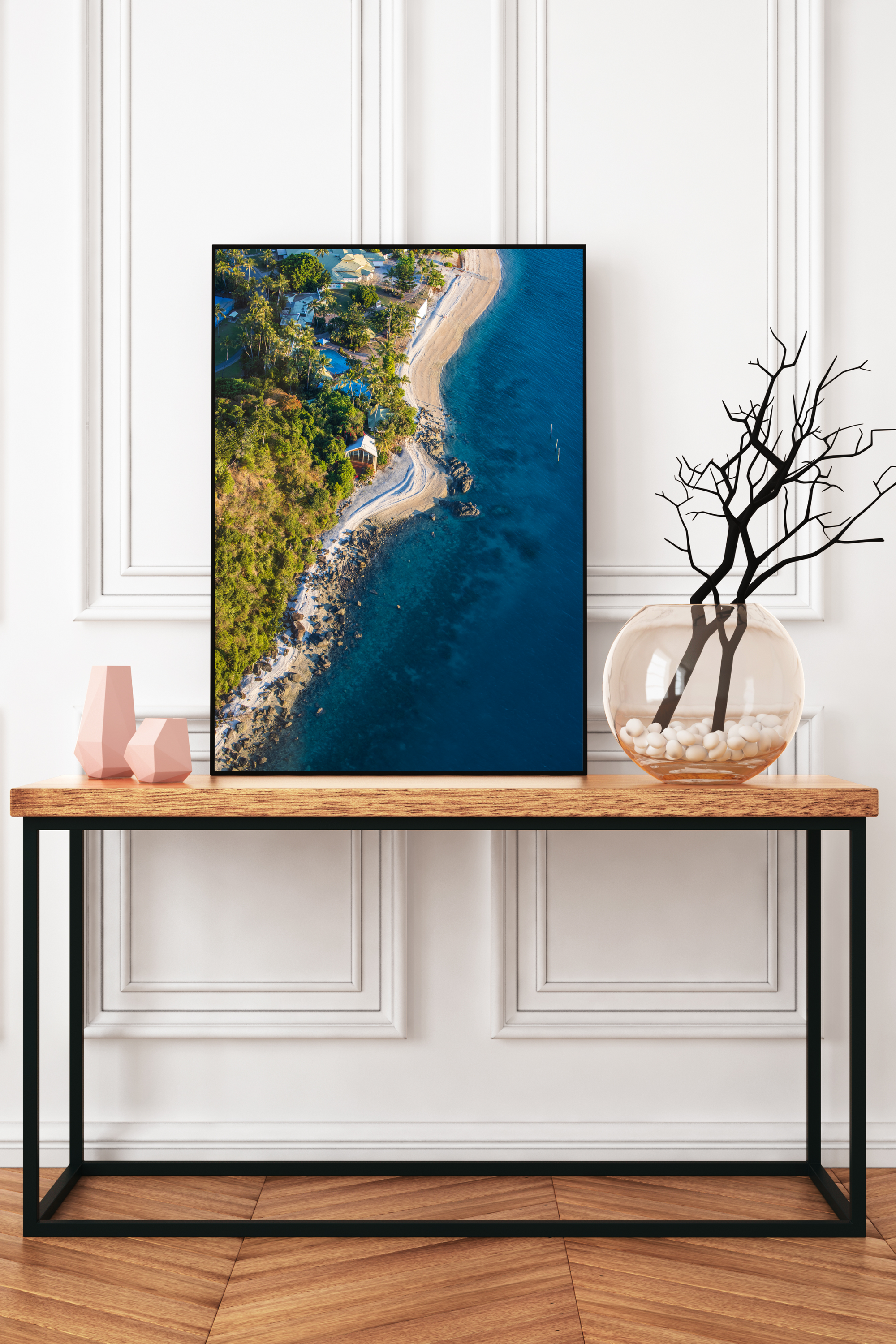 from above coastline with water on the right rocky sand beach, buildings and a chapel on the shoreline
