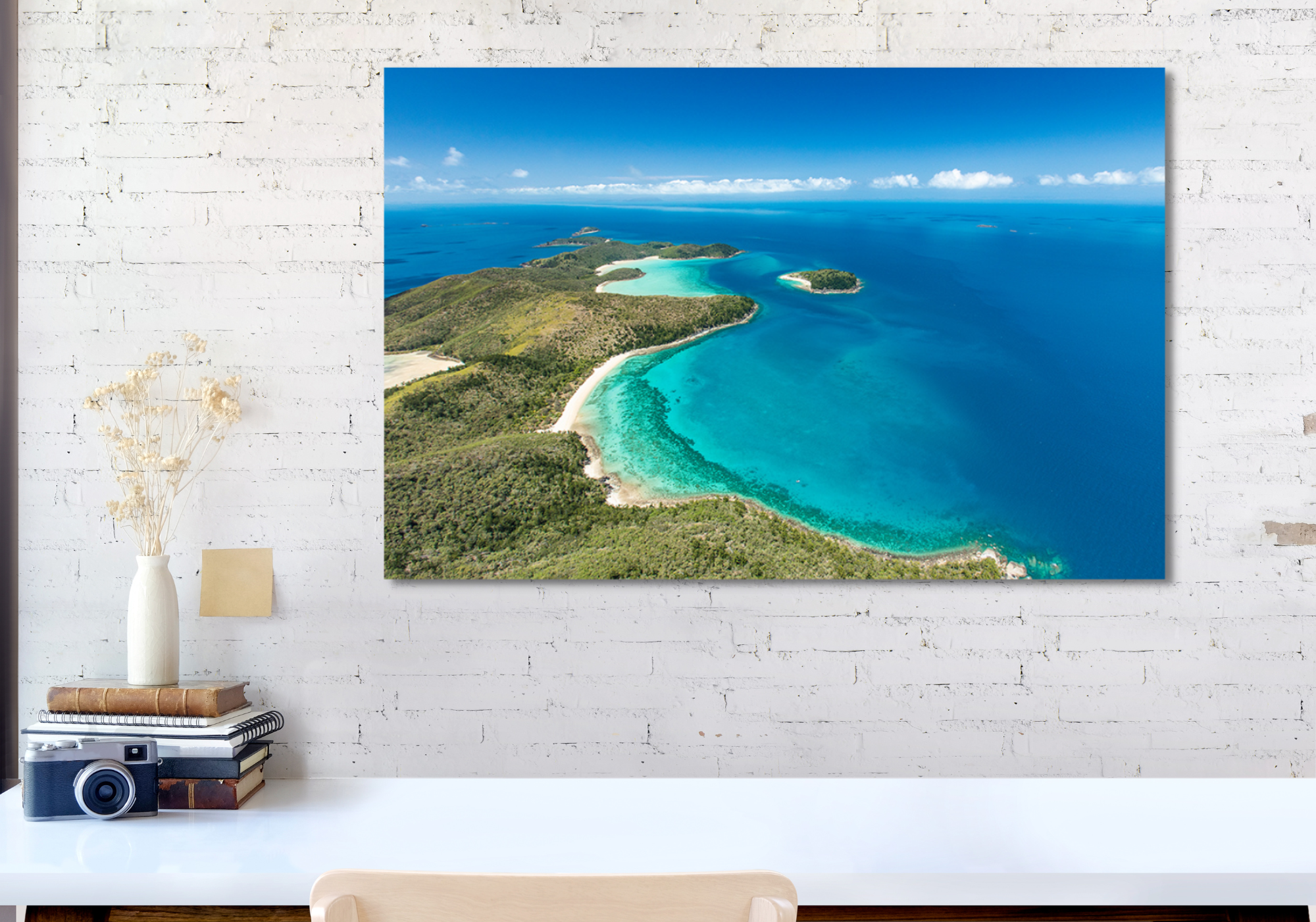 aerial shot of an island dotted with bays of coral and sand