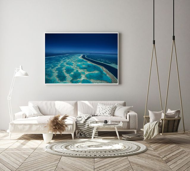 far and wide coral reef in blue and green colours with deep channel of water