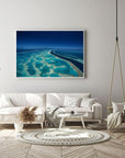 far and wide coral reef in blue and green colours with deep channel of water