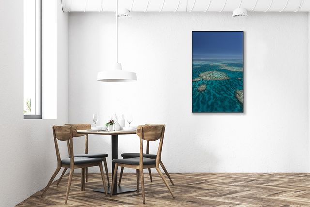 large archipelago of veiny coral reefs dotted about blue green ocean water