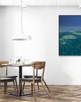 large archipelago of veiny coral reefs dotted about blue green ocean water
