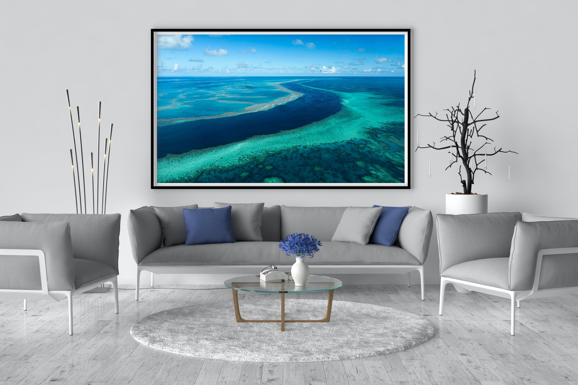 4 vessels anchored within a protected calm bay and different coloured ocean waters beyond