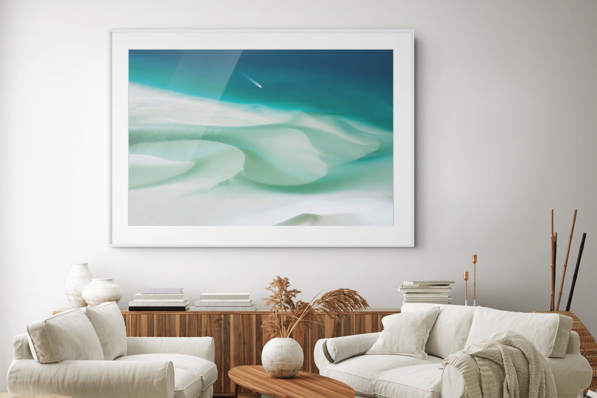 Living room with white sofa, wooden coffee table, and abstract artwork on the wall.