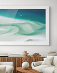 Living room with white sofa, wooden coffee table, and abstract artwork on the wall.