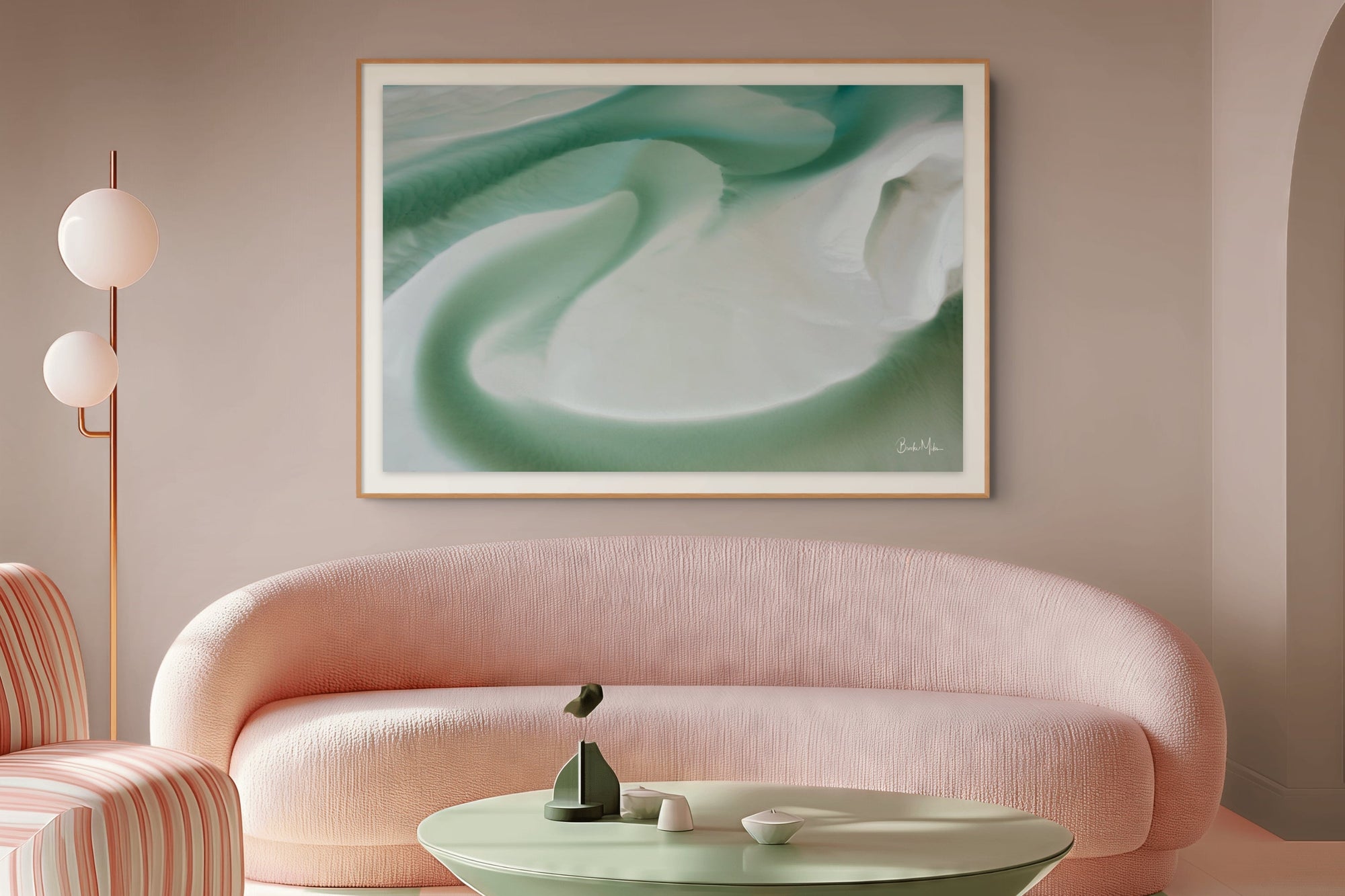 Modern living room with a pink sofa, striped armchair, and green silica on the wall.