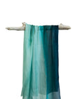 Silk Sarong Comet Print of a small boat in the distance replicates a comet amongst the sand and blue green water swirling together