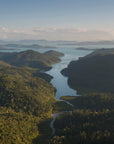 afternoon light setting over the hills of an island with a passage of water running down the middle