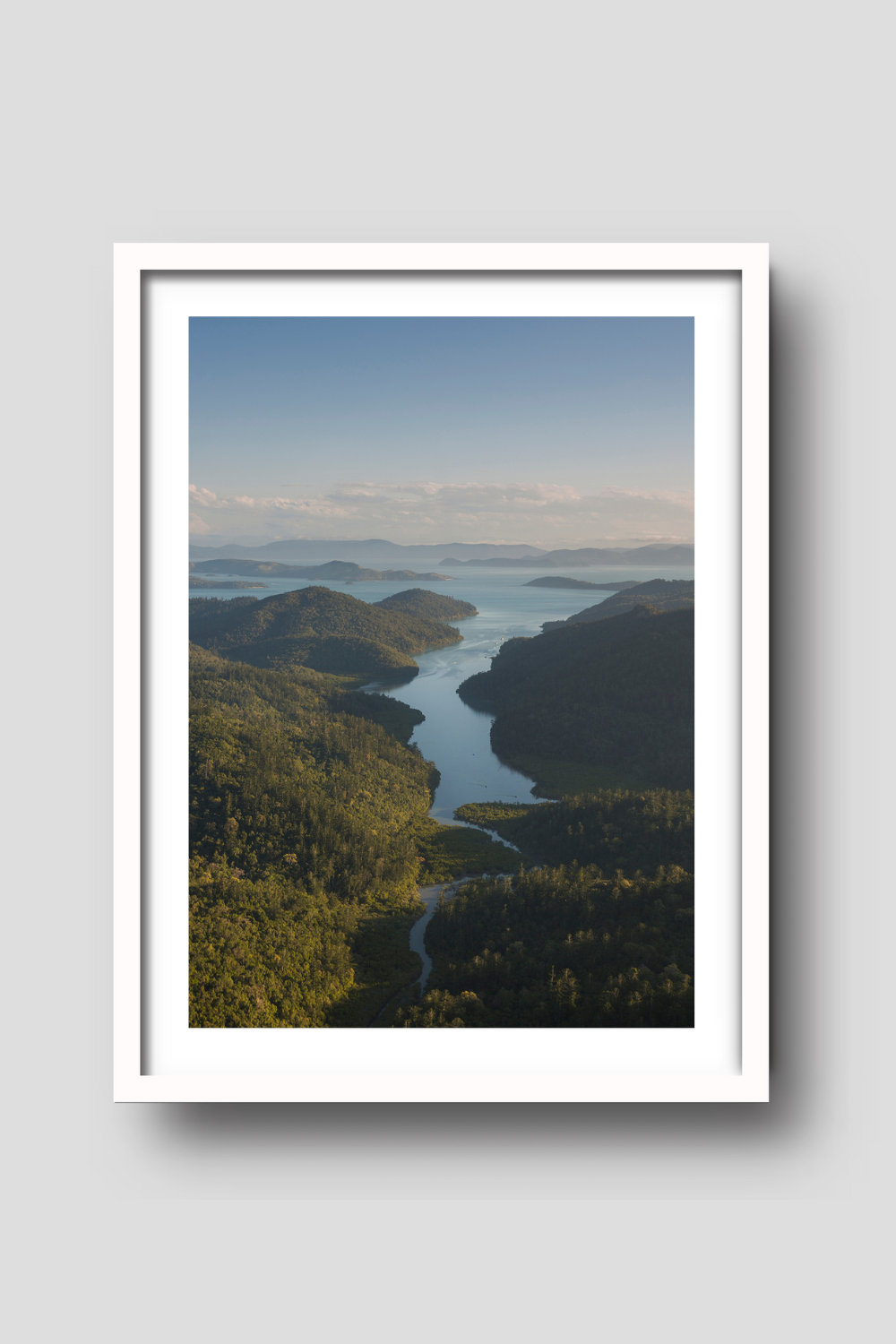 afternoon light setting over the hills of an island with a passage of water running down the middle